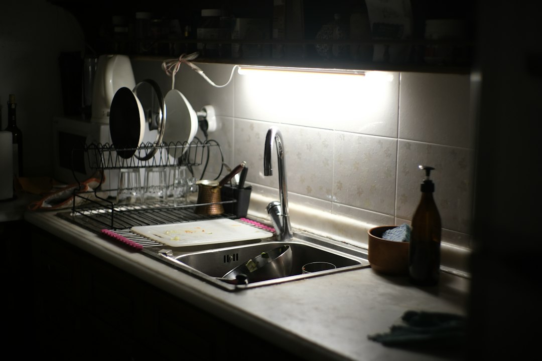 Under sink organization ideas around a kitchen sink