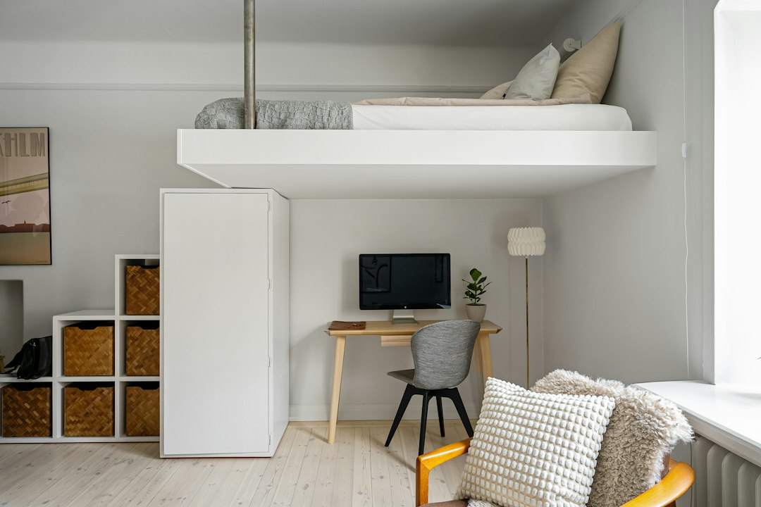 Small space storage ideas with a loft bed and compact workspace