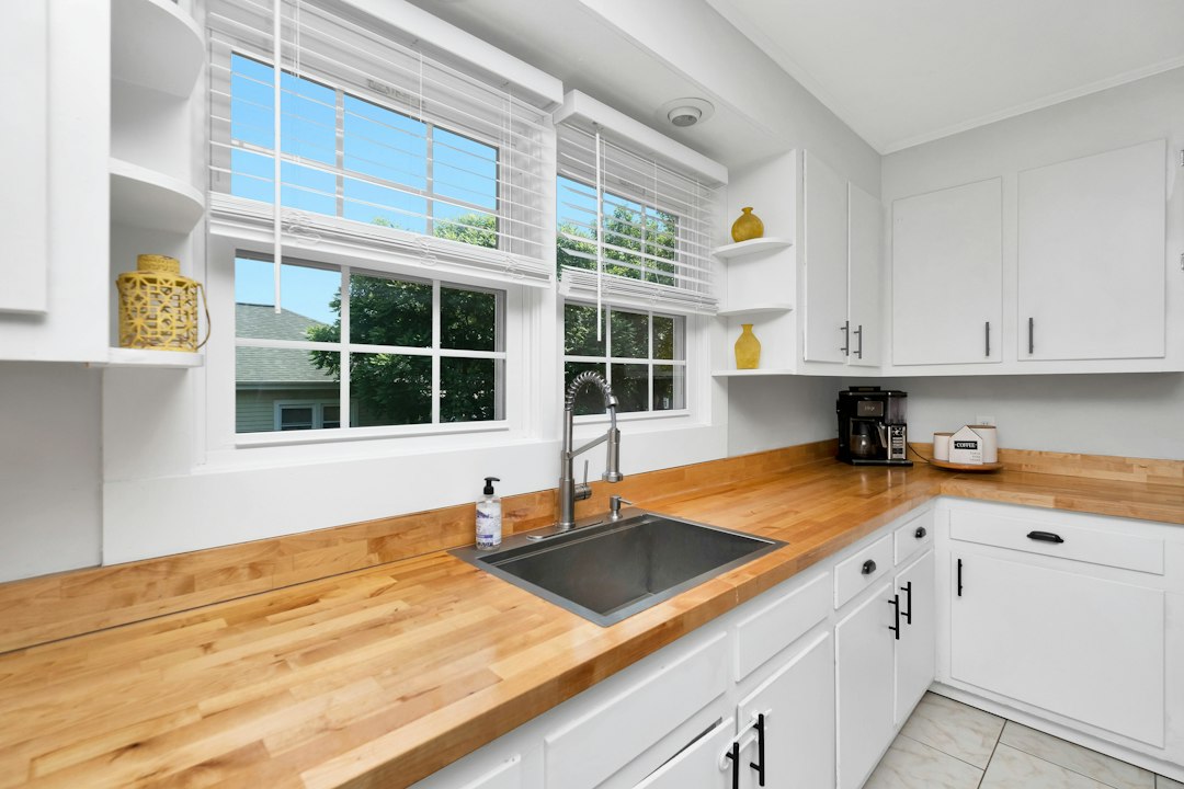 White kitchen cabinets and sink in a compact kitchen